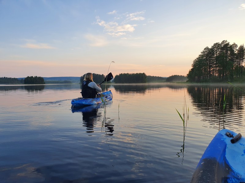 a boat on a lake next to a body of water